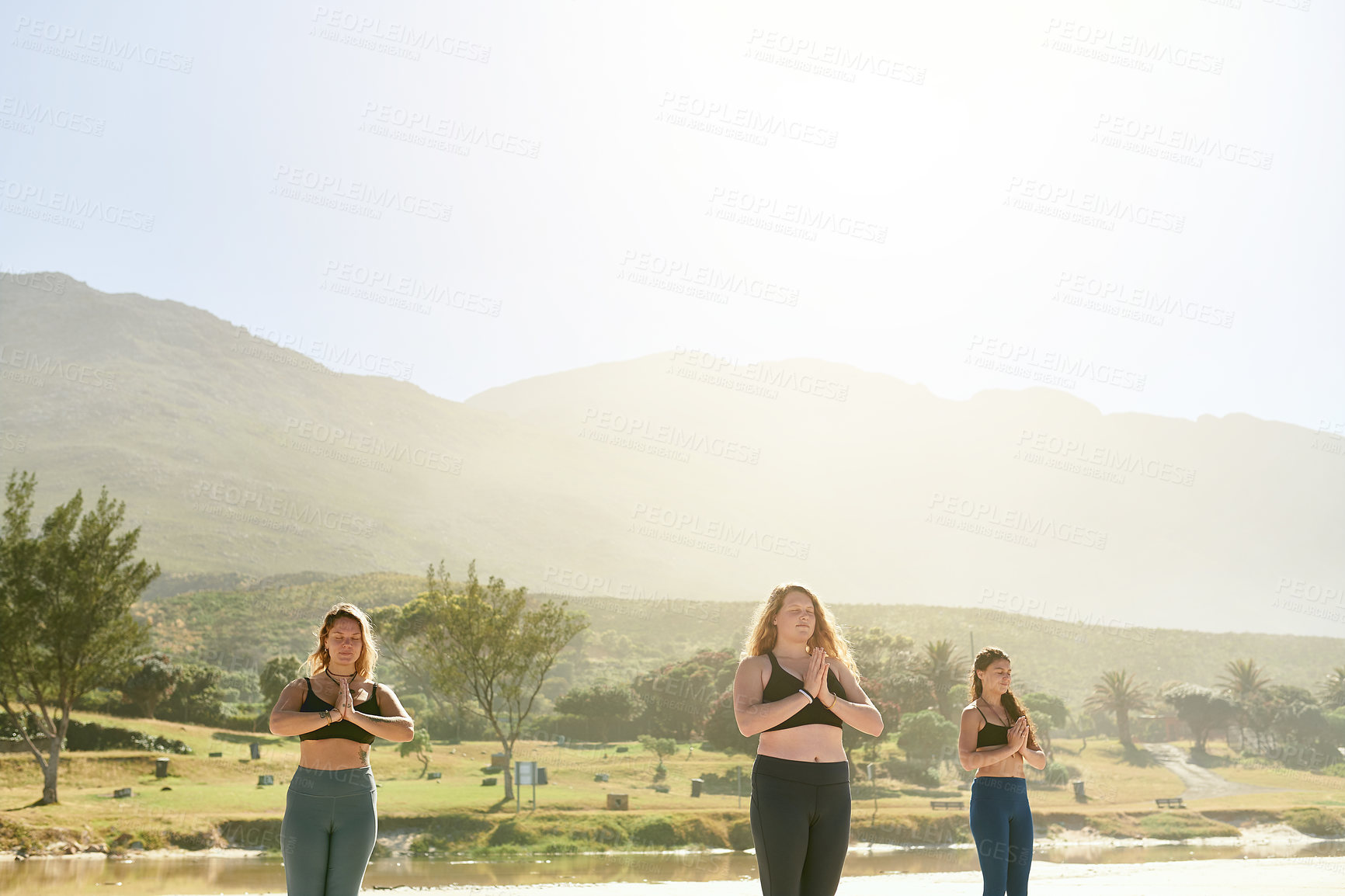 Buy stock photo Beach, group and women with namaste for meditation, wellness and inner peace for mindfulness outdoor. Nature, people and instructor with prayer hands for yoga class, mental health and holistic energy