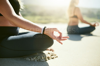 Buy stock photo Cropped shot of an unrecognizable woman practising yoga on the beach