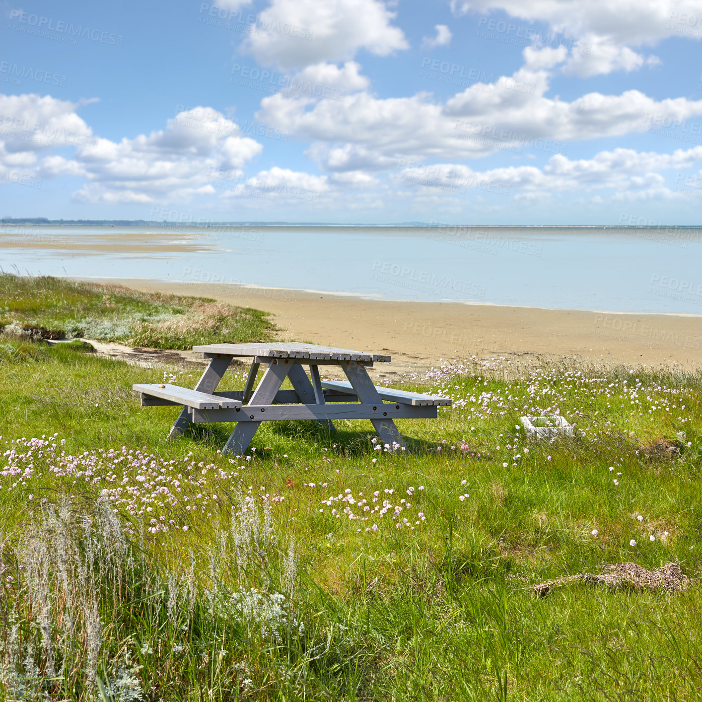 Buy stock photo Wooden bench and table by the East Coast of Jutland, Denmark for a picnic by the sea outside. Seating furniture at the beach to enjoy a meal at while taking a break and rest from travel and exploring