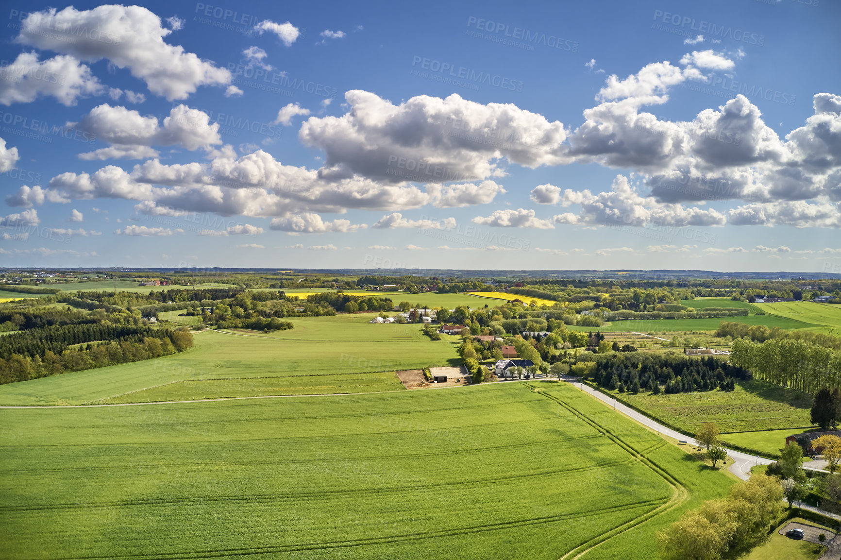 Buy stock photo Scenic remote landscape view of a green farmland on the countryside of Jutland, Denmark. Secluded and empty grassland against a cloudy blue sky in summer. Deserted scenery in a quiet rural area