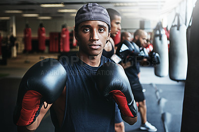 Buy stock photo Shot of a male boxer training at the gym