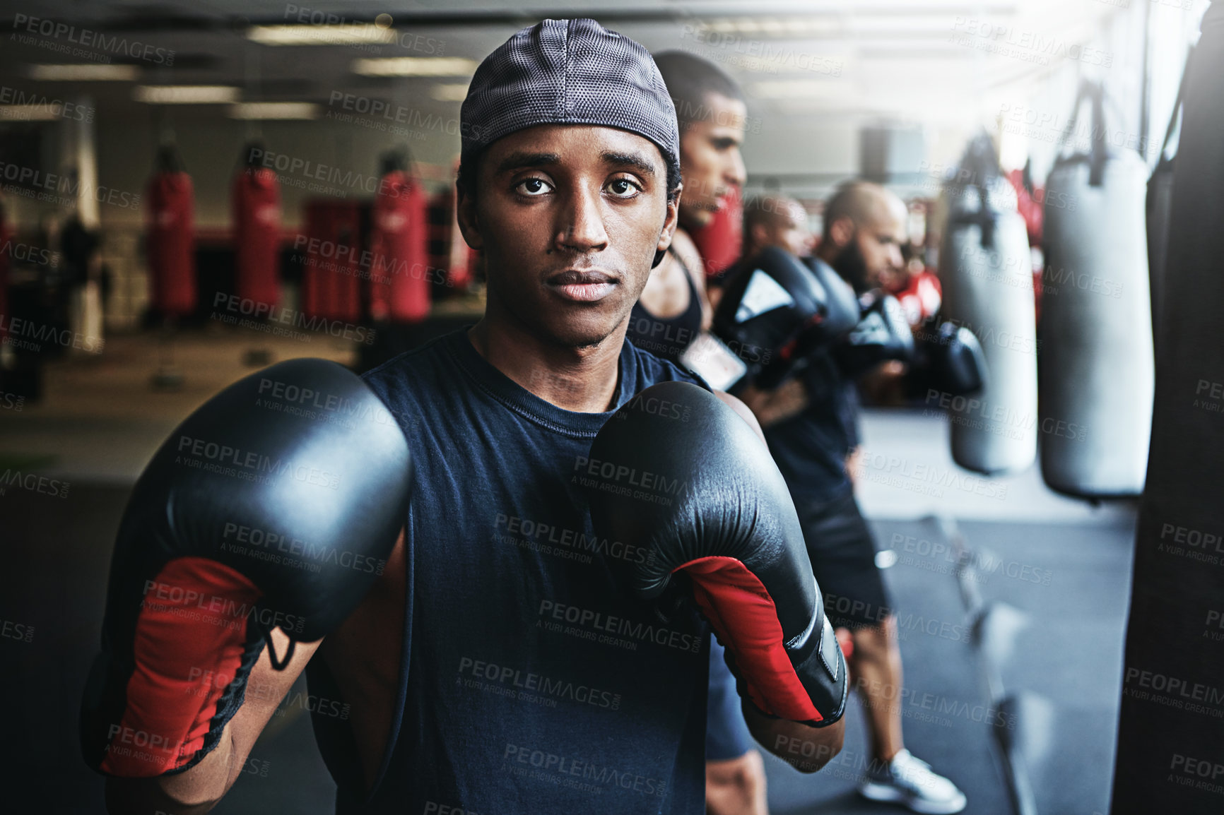 Buy stock photo Shot of a male boxer training at the gym