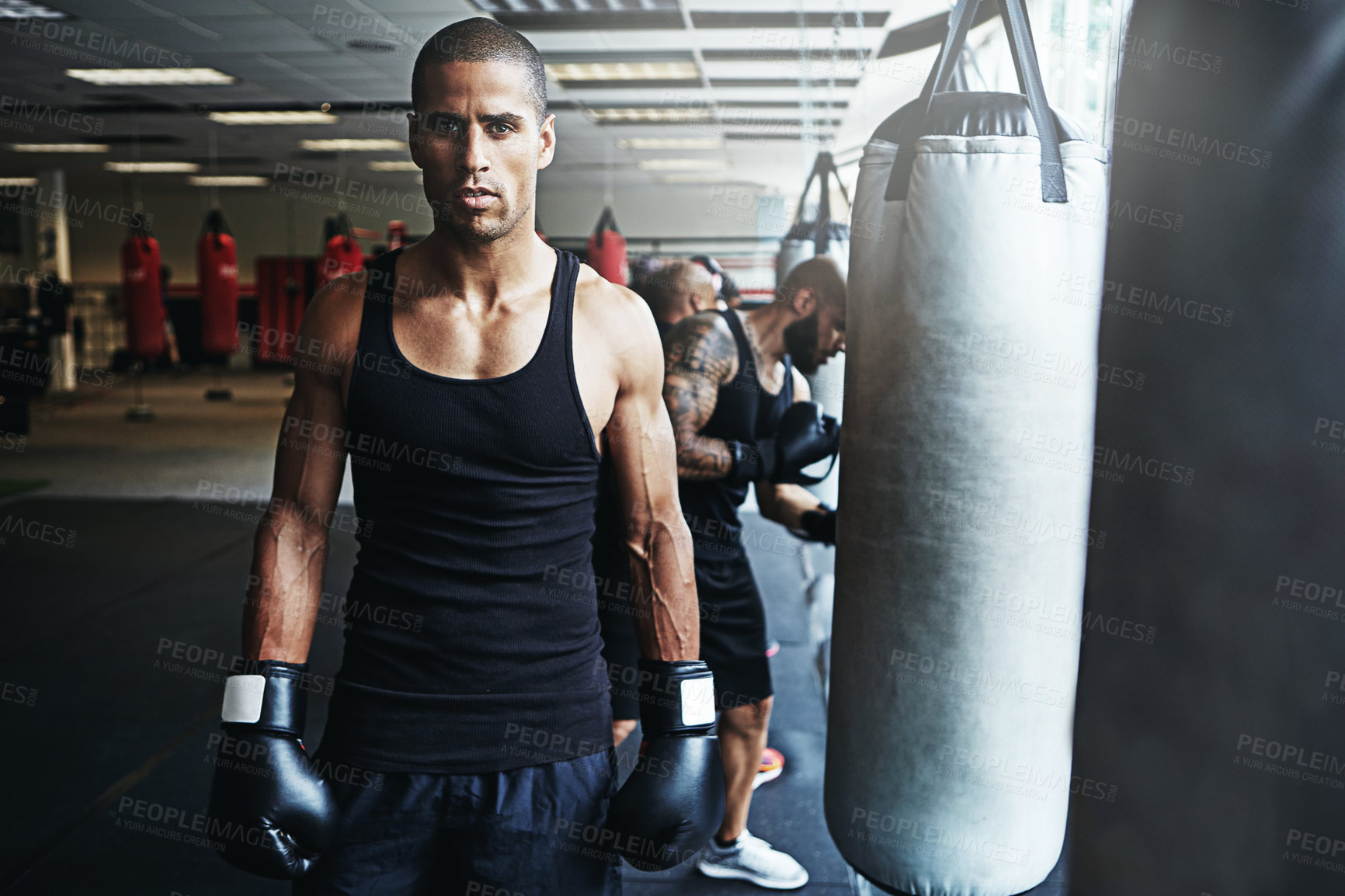 Buy stock photo Shot of a male boxer training at the gym