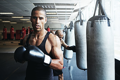 Buy stock photo Shot of a male boxer training at the gym