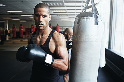 Buy stock photo Shot of a male boxer training at the gym