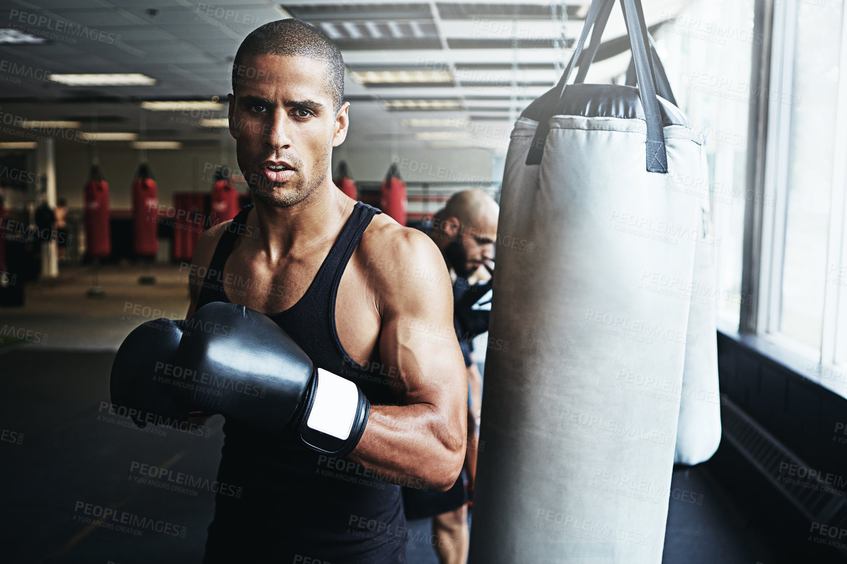 Buy stock photo Shot of a male boxer training at the gym