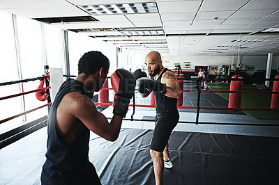 Buy stock photo Shot of two male boxers sharing a ring