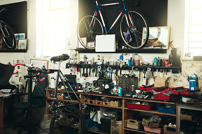 Buy stock photo Shot of a bicycles and equipment in a workshop
