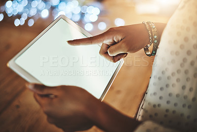 Buy stock photo Cropped shot of a businesswoman using a digital tablet during a late night at work