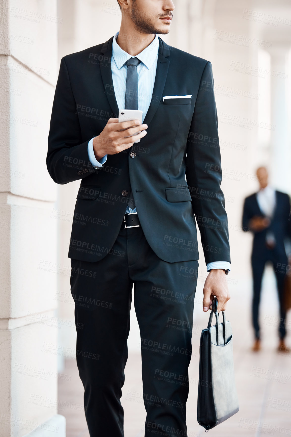 Buy stock photo Cropped shot of an unrecognizable businessman using a cellphone outside