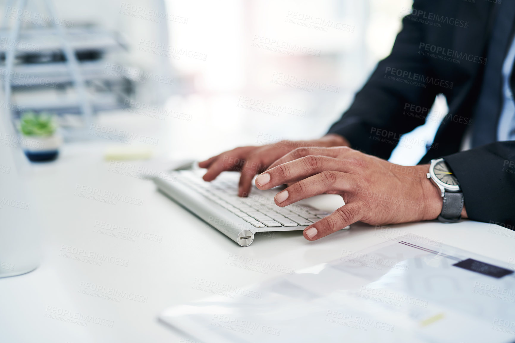 Buy stock photo Closeup shot of an unrecognisable businessman working on a computer in an office