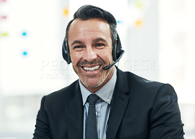 Buy stock photo Portrait of a mature businessman wearing a headset while working in an office