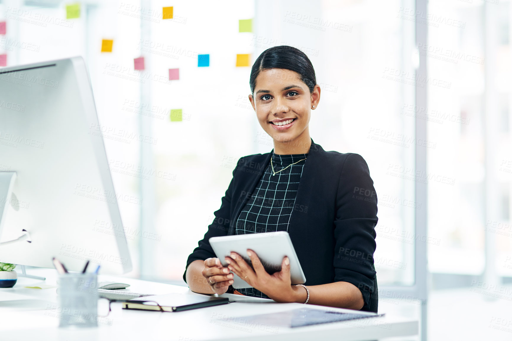 Buy stock photo Portrait of a young businesswoman using a digital tablet in an office