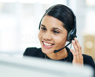 Buy stock photo Shot of a young businesswoman using a headset while working on a computer in an office