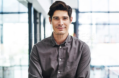 Buy stock photo Cropped portrait of a handsome young businessman standing in a modern office