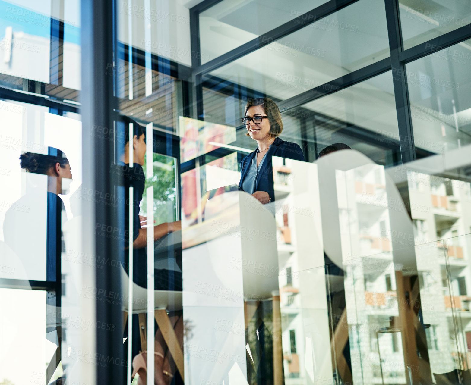 Buy stock photo Cropped shot of a diverse group of businesspeople having a meeting in a boardroom