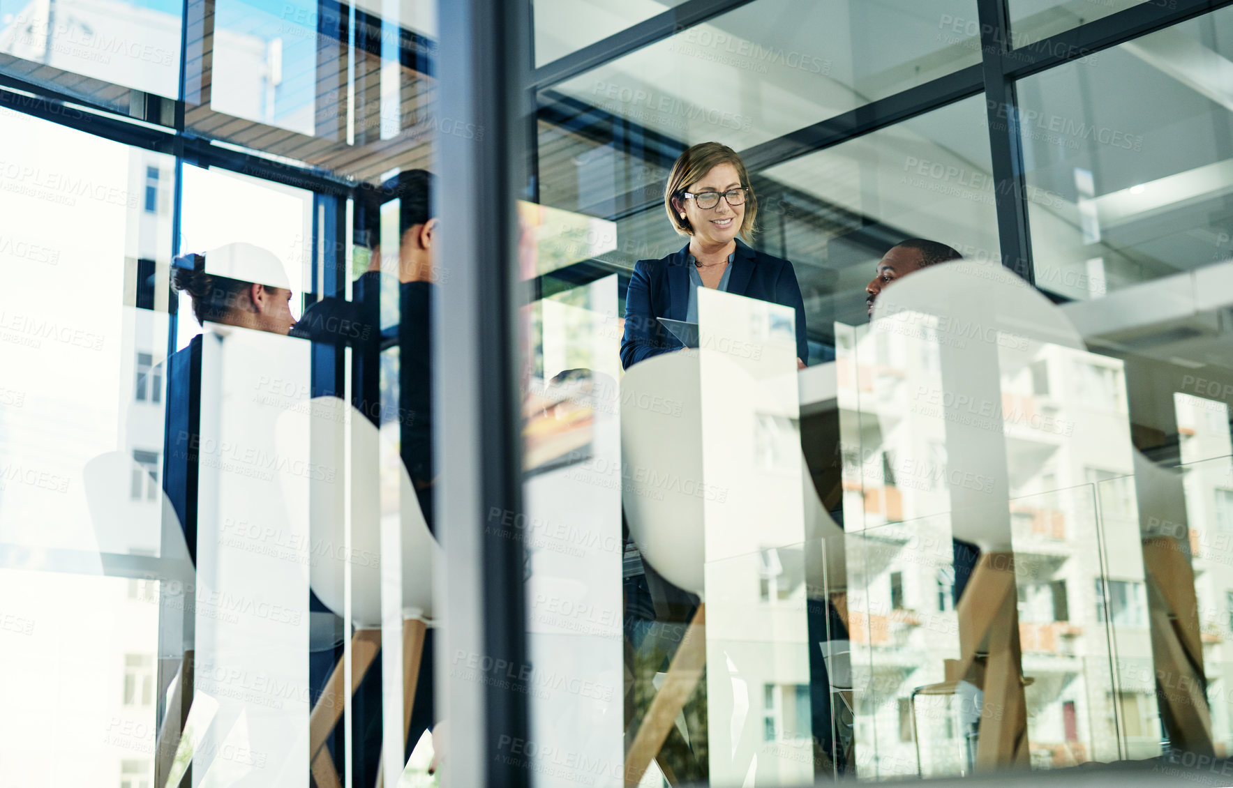 Buy stock photo Cropped shot of a diverse group of businesspeople having a meeting in a boardroom