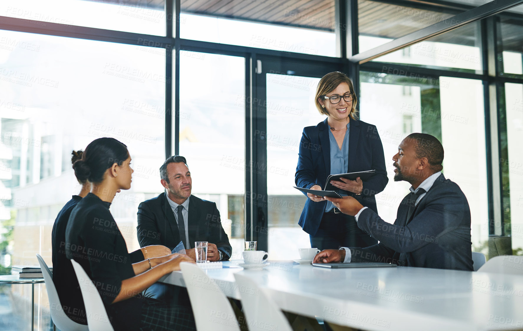 Buy stock photo Cropped shot of a diverse group of businesspeople having a meeting in a boardroom