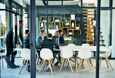 Buy stock photo Full length shot of a diverse group of businesspeople having a meeting in a boardroom