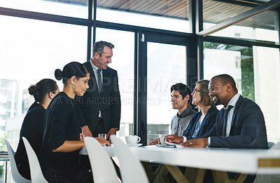 Buy stock photo Cropped shot of a diverse group of businesspeople having a meeting in a boardroom