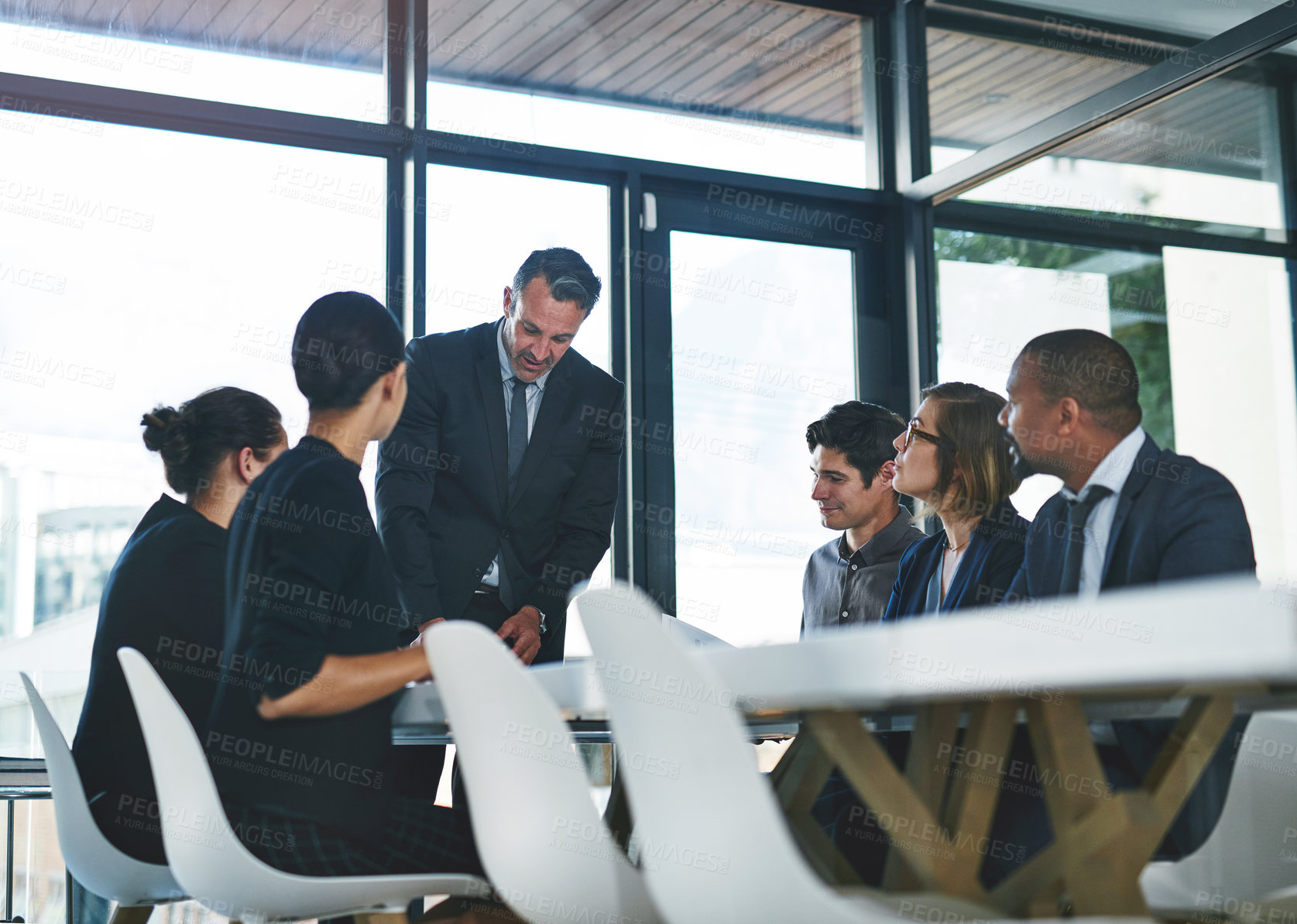 Buy stock photo Cropped shot of a diverse group of businesspeople having a meeting in a boardroom