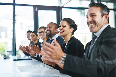 Buy stock photo Cropped shot of a diverse group of young businesspeople applauding during a conference