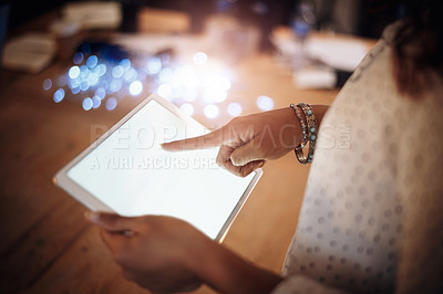 Buy stock photo Closeup shot of an unrecognisable businesswoman using a digital tablet in an office at night
