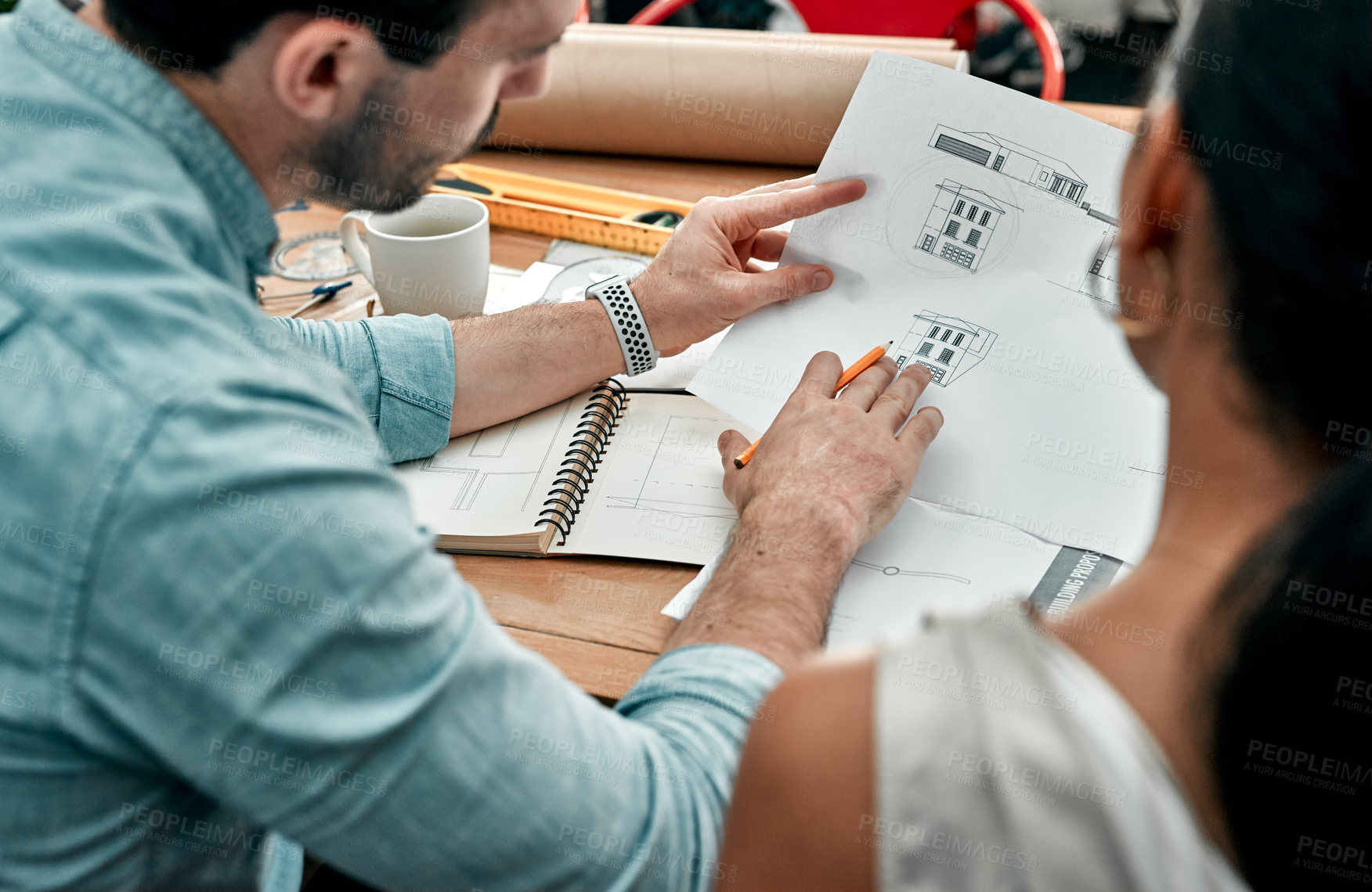 Buy stock photo Closeup shot of two architects working with blueprints in an office