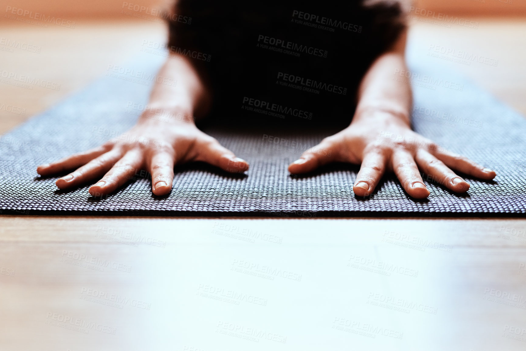 Buy stock photo Shot of a fit young woman practicing the child’s pose during a yoga session