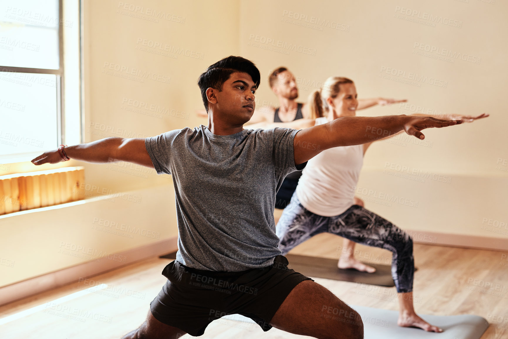 Buy stock photo Warrior pose, yoga and fitness with people in class for holistic health, flexibility and workout. Pilates, exercise and healing with group of friends in studio for breathing, zen and wellness balance