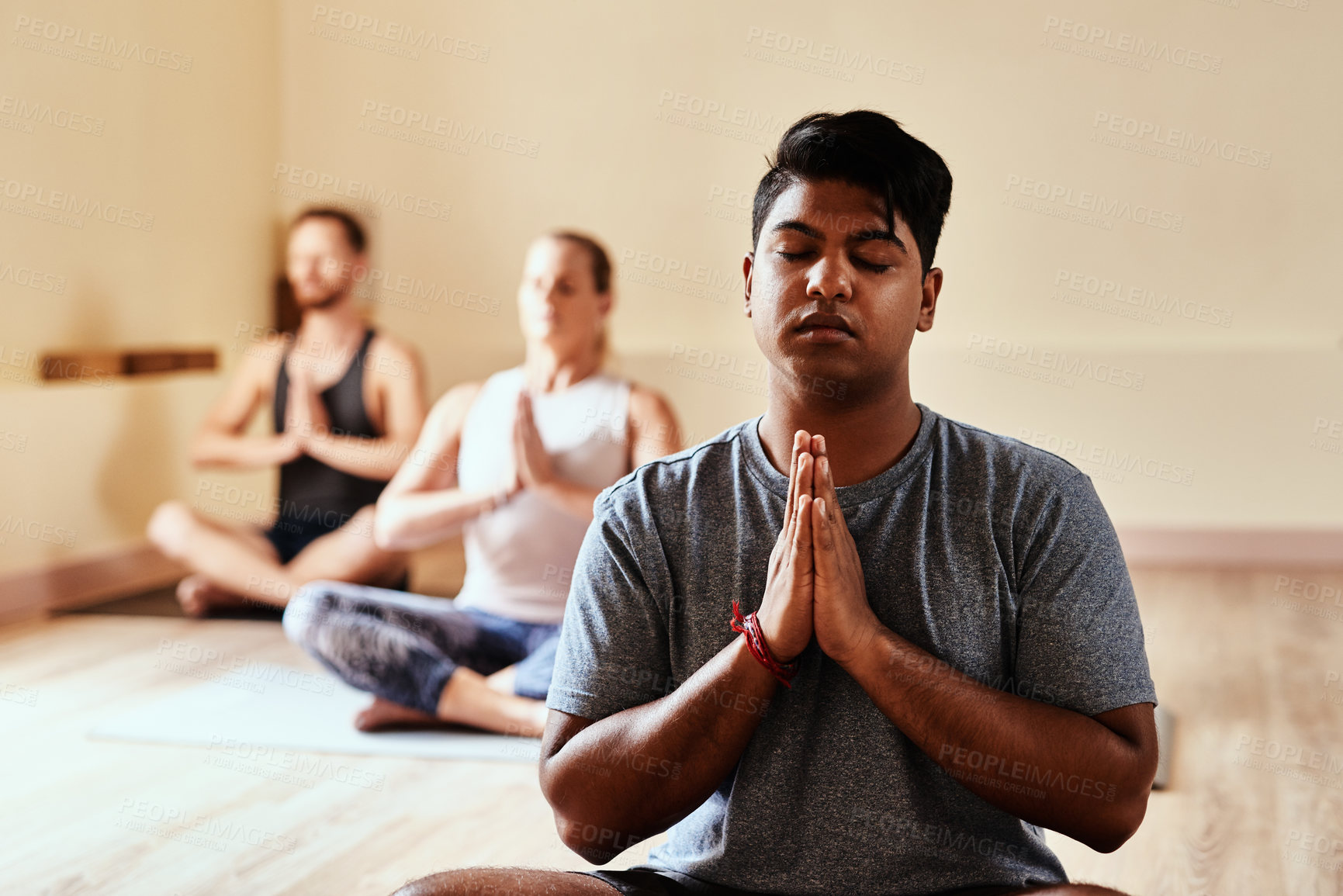 Buy stock photo Meditation, yoga and healing with man in class for holistic health, zen and workout. Pilates, exercise and wellness with group of people for breathing, prayer hands and spiritual balance together