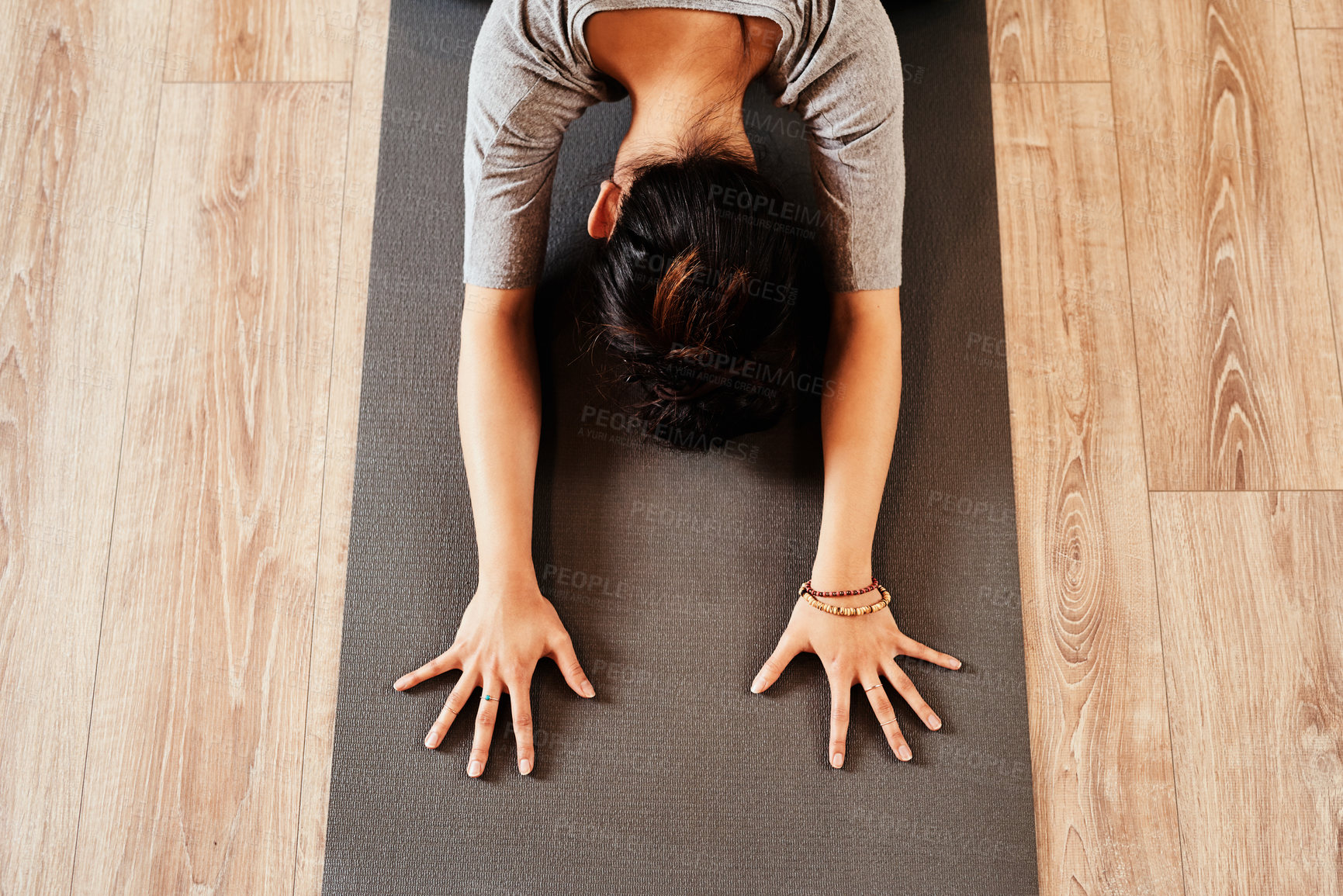 Buy stock photo Shot of a fit young woman practicing the child’s pose during a yoga session