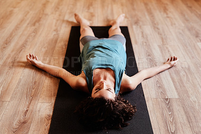 Buy stock photo Shot of a young woman resting after her yoga session