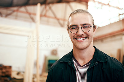 Buy stock photo Portrait of a handsome young carpenter working inside his workshop