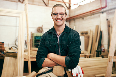 Buy stock photo Portrait of a handsome young carpenter posing with his arms folded inside his workshop