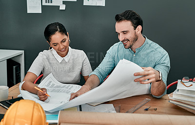 Buy stock photo Shot of two architects working with blueprints in an office