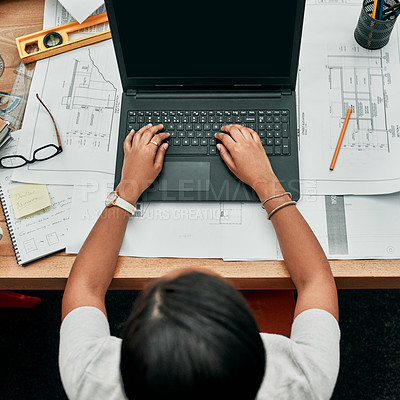 Buy stock photo High angle shot of an architect working on a laptop in an office