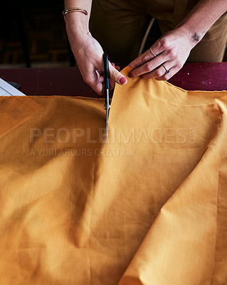 Buy stock photo Cropped shot of an unrecognizable fashion designer cutting fabric