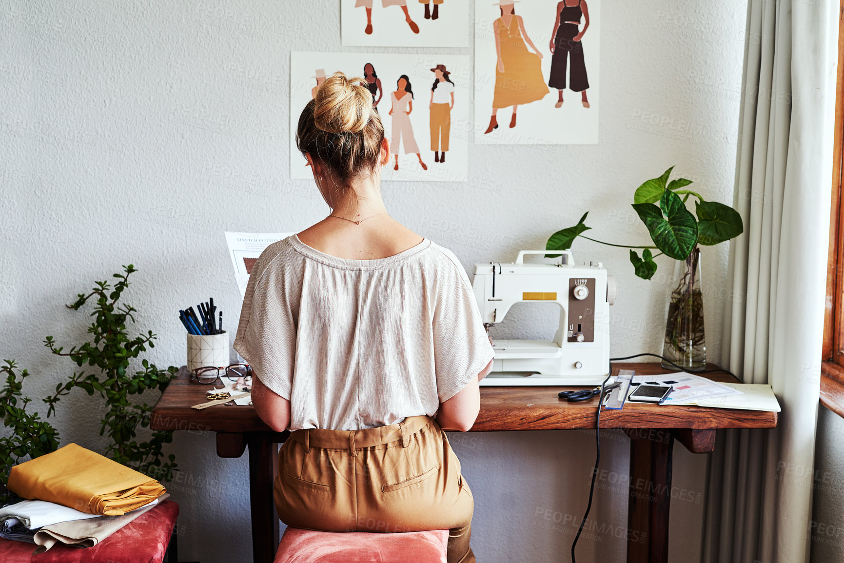 Buy stock photo Fashion, design and back of woman at sewing machine in small business, creative ideas and focus in studio. Creativity, sustainable startup and designer, tailor or young entrepreneur working at table.