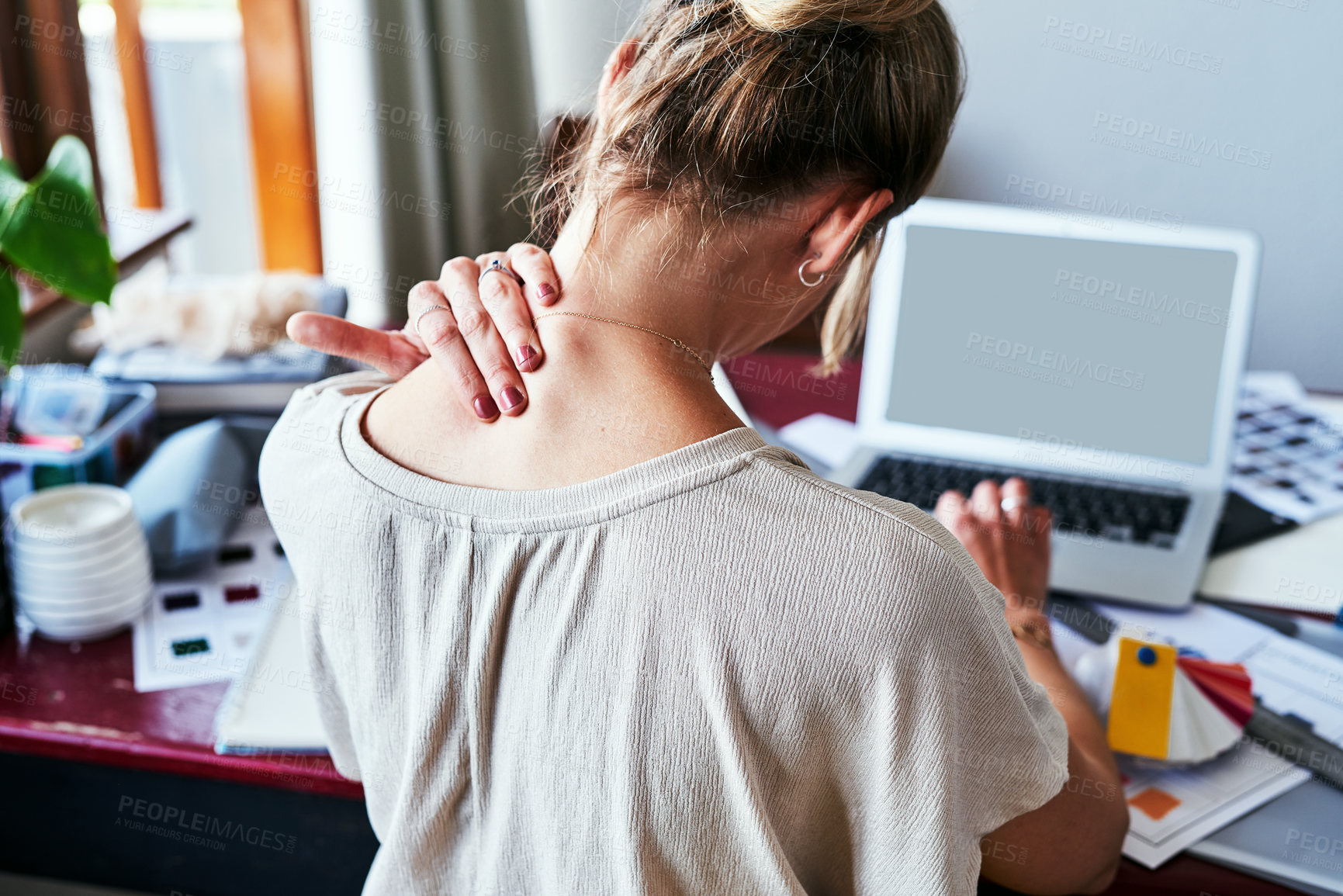 Buy stock photo Neck pain, mockup and laptop screen with back of woman in fashion design studio for website, tired and frustrated. Stress, burnout and mental health with designer for planning, anxiety and tension