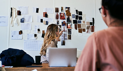 Buy stock photo Cropped shot of two fashion designers working together in a workshop