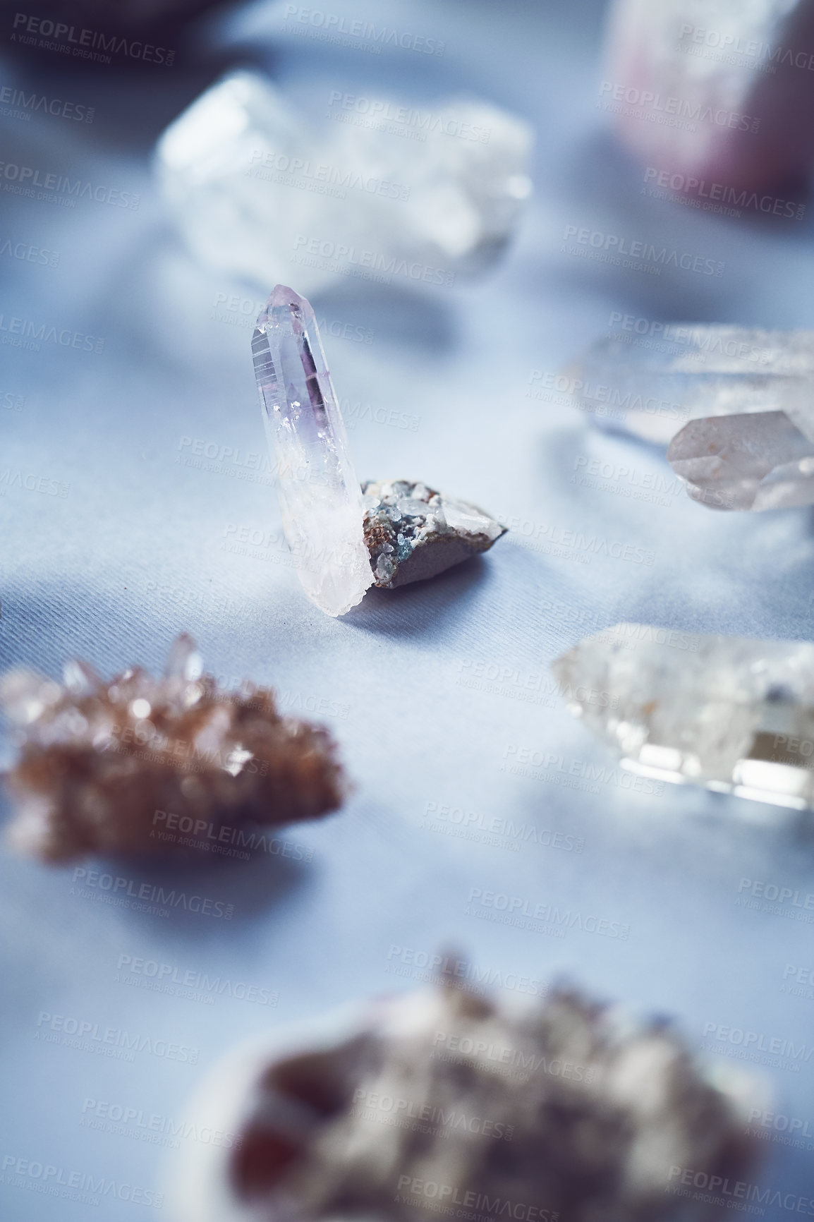 Buy stock photo Closeup of a table filled with different types of crystals inside during the day