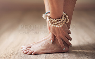 Buy stock photo Cropped shot of an unrecognizable woman standing alone and stretching while holding her feet in a yoga studio