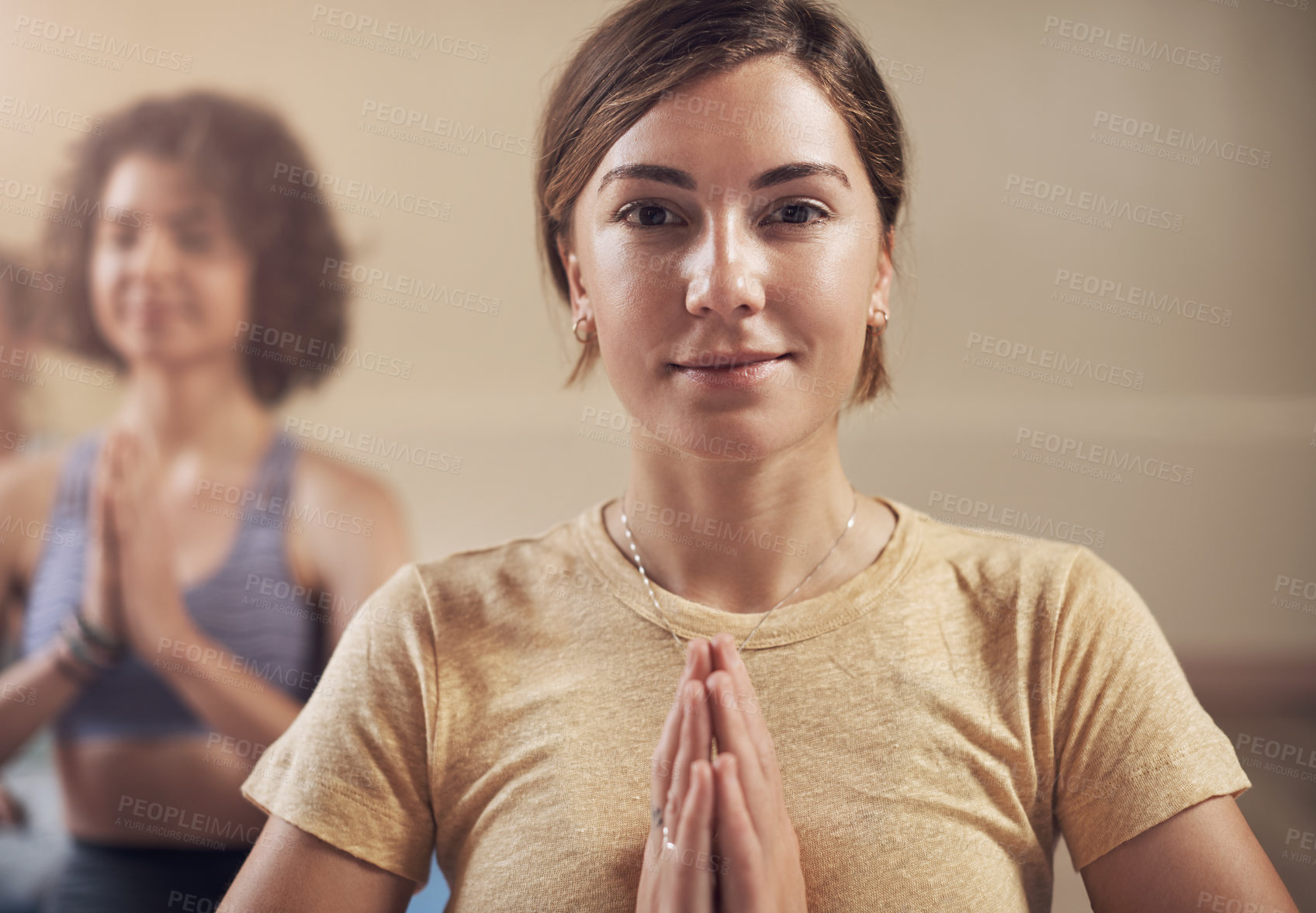 Buy stock photo Cropped portrait of a young group of women sitting together and meditating after an indoor yoga session