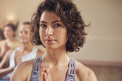 Buy stock photo Cropped portrait of a young group of women sitting together and meditating after an indoor yoga session