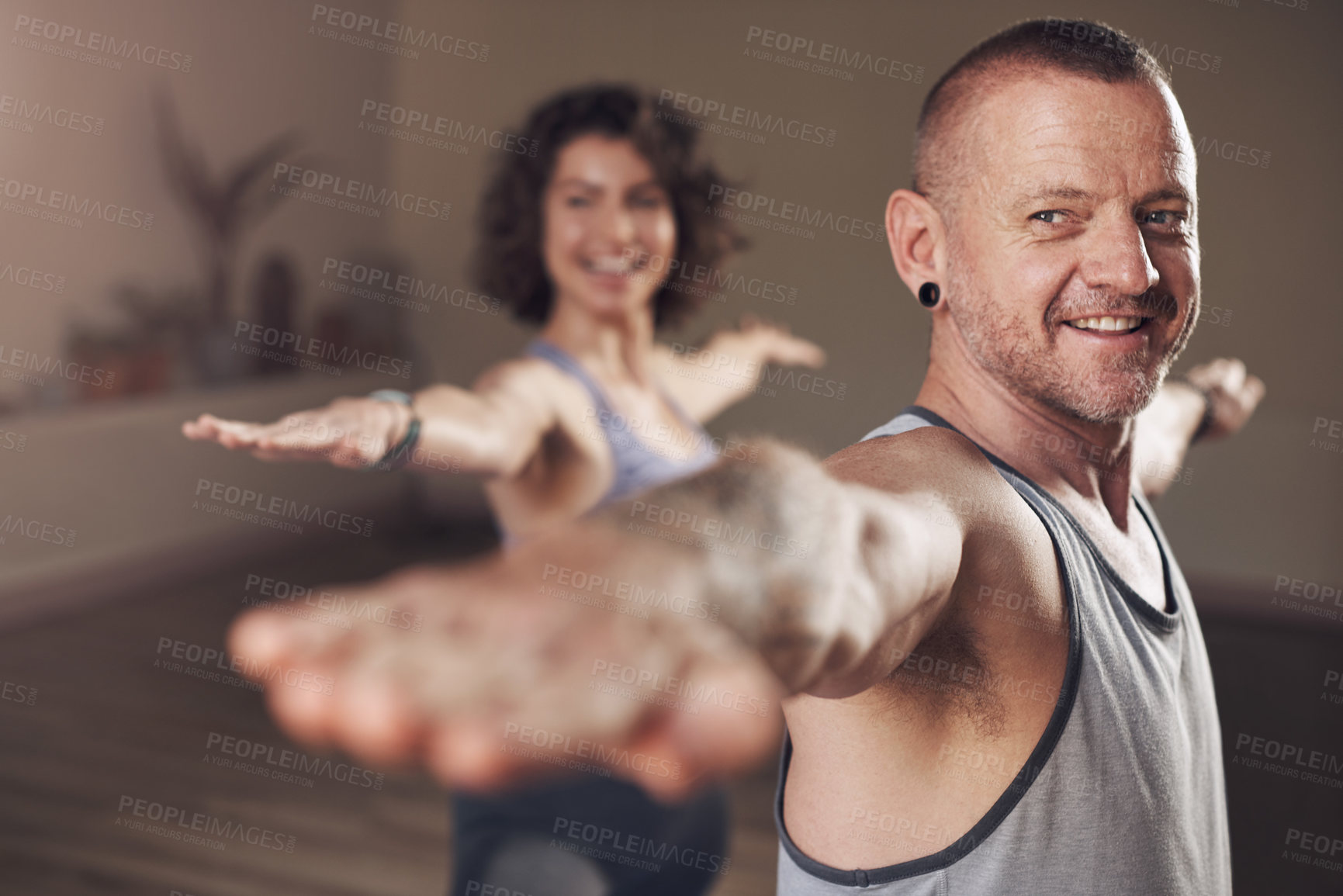 Buy stock photo Happy man, yoga and warrior pose in studio for health, wellness and body flexibility for practice routine. Smile, male yogi or person in pilates session for mindfulness, wellbeing or balance in class