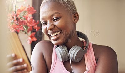 Buy stock photo Cropped shot of an attractive young woman sitting alone and using her cellphone after an indoor yoga session