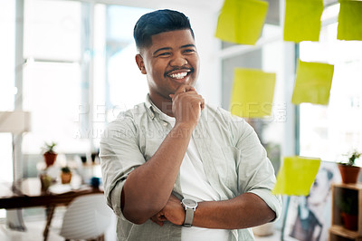 Buy stock photo Shot of a young businessman having a brainstorming session in a modern office