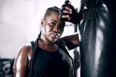 Buy stock photo Black woman, portrait and boxing bag for fitness, sweat and confidence for workout. Training, combat sports and cardio for body health and wellness, serious and gloves for African person in gym