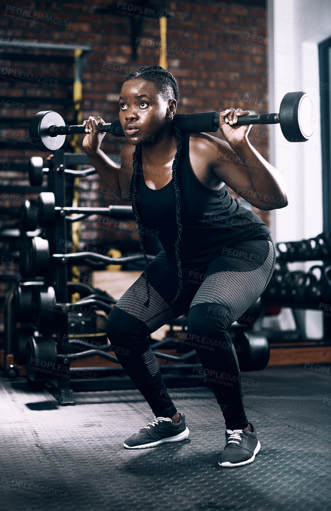 Buy stock photo Full length shot of an attractive young female athlete lifting weights in the gym